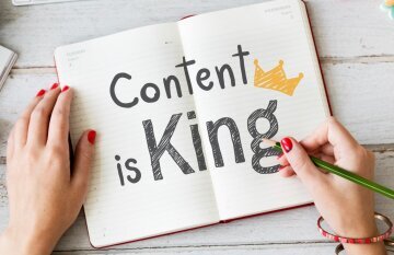 woman_writing_content_is_king_notebook